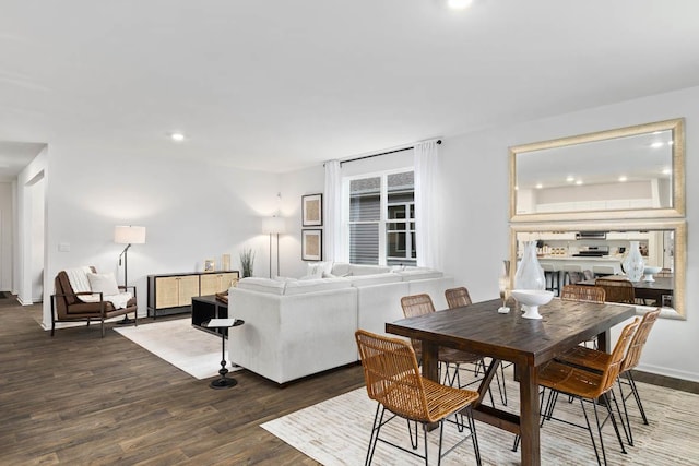 dining room featuring wood finished floors, recessed lighting, and baseboards