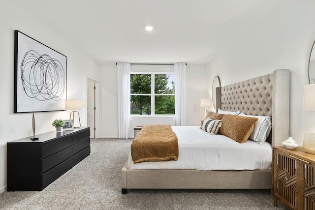 carpeted bedroom featuring baseboards