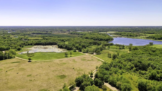 bird's eye view of a nearby body of water and a heavily wooded area