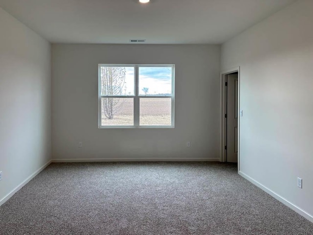 empty room with carpet and baseboards