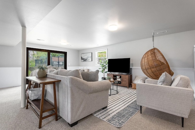 living area with light carpet and visible vents