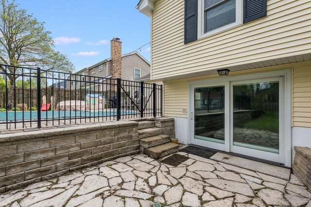 view of patio with a pool and fence