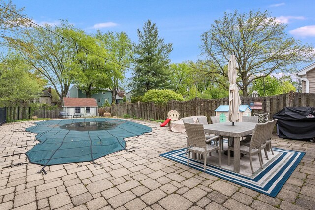 view of pool with a fenced backyard, a patio area, a fenced in pool, and a grill