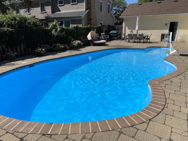 view of swimming pool featuring fence, a patio, a fenced in pool, and outdoor dining space