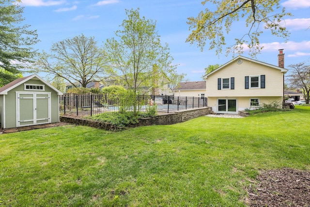 view of yard with fence, a storage shed, and an outbuilding