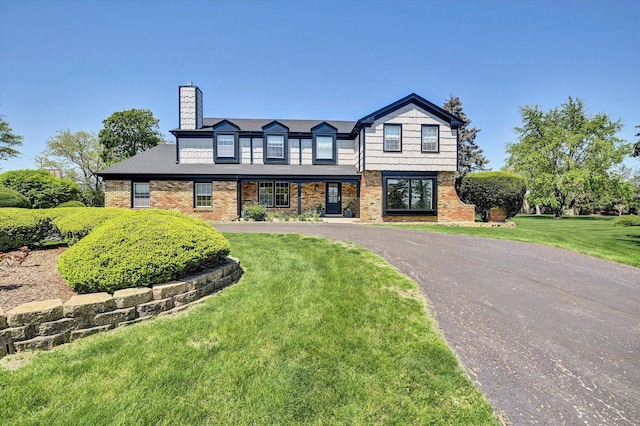 8 Wyndham Ct, Oak Brook, IL 60523 - view of front of house with a chimney, a front lawn, brick siding, and asphalt driveway