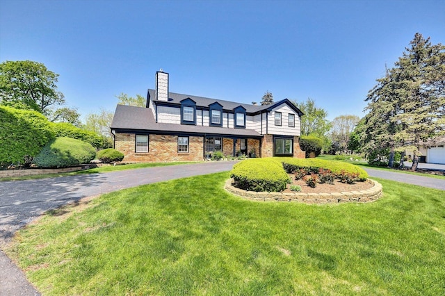8 Wyndham Ct, Oak Brook, IL 60523 - view of front of house featuring curved driveway, a front lawn, a chimney, and brick siding
