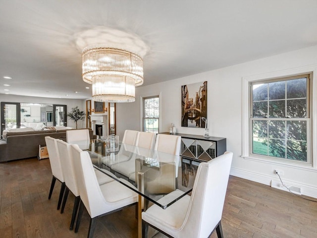 8 Wyndham Ct, Oak Brook, IL 60523 - dining room with hardwood / wood-style flooring, a chandelier, baseboards, recessed lighting, and a fireplace