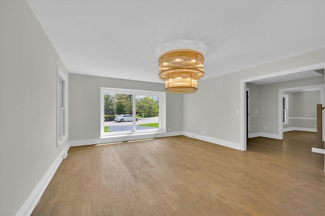 8 Wyndham Ct, Oak Brook, IL 60523 - unfurnished room featuring wood finished floors, a chandelier, and baseboards