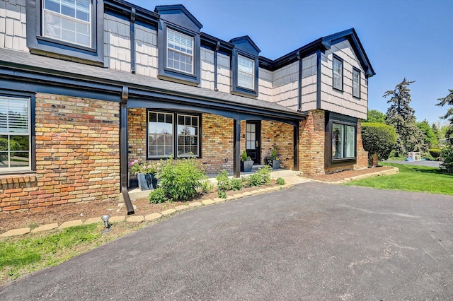 8 Wyndham Ct, Oak Brook, IL 60523 - townhome / multi-family property with brick siding and a porch
