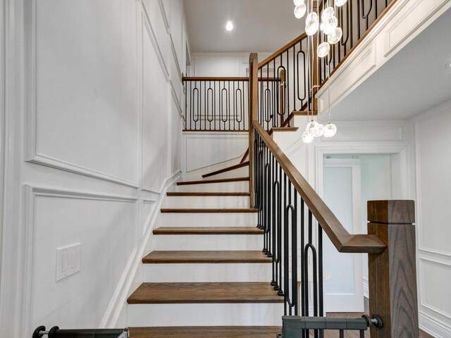 8 Wyndham Ct, Oak Brook, IL 60523 - stairway featuring a decorative wall, a chandelier, and recessed lighting