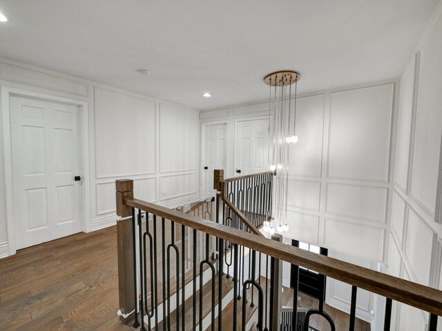 8 Wyndham Ct, Oak Brook, IL 60523 - hallway featuring a decorative wall, an upstairs landing, dark wood-style flooring, and recessed lighting