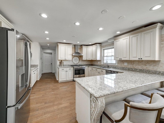 8 Wyndham Ct, Oak Brook, IL 60523 - kitchen with appliances with stainless steel finishes, wall chimney range hood, a peninsula, a kitchen bar, and recessed lighting