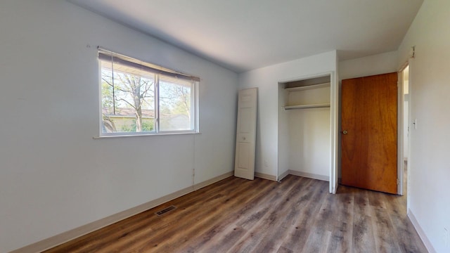 3320 Kimberly Dr, Champaign, IL 61821 - unfurnished bedroom featuring wood finished floors, a closet, and baseboards