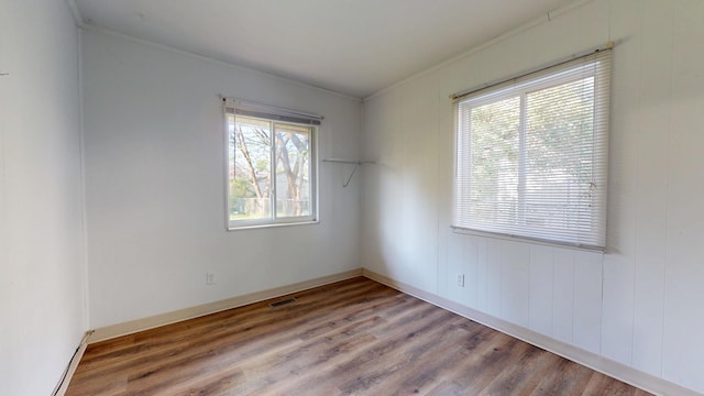 3320 Kimberly Dr, Champaign, IL 61821 - spare room featuring ornamental molding, wood finished floors, and a baseboard heating unit
