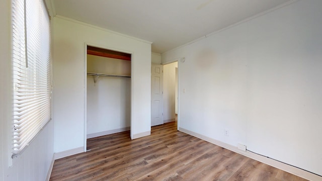 3320 Kimberly Dr, Champaign, IL 61821 - unfurnished bedroom with ornamental molding, wood finished floors, a closet, and baseboards