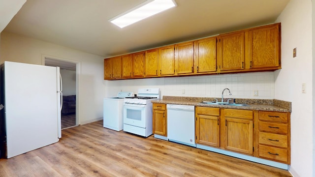 3320 Kimberly Dr, Champaign, IL 61821 - kitchen featuring white appliances, a sink, washer / dryer, light wood-style floors, and decorative backsplash