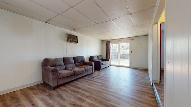 3320 Kimberly Dr, Champaign, IL 61821 - living area featuring a paneled ceiling, wood finished floors, baseboards, and a wall mounted AC