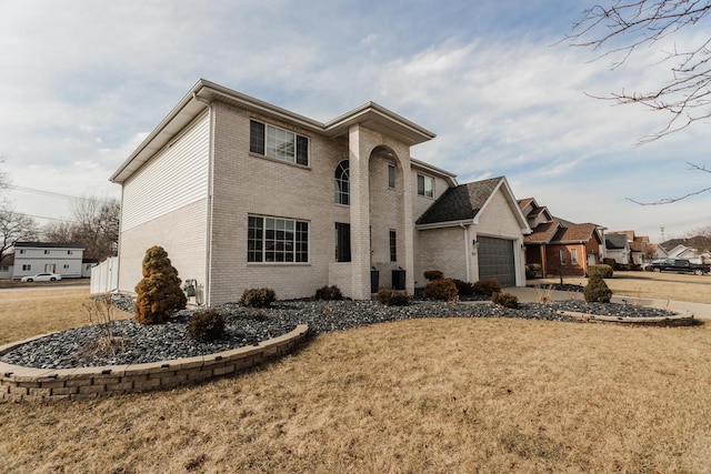 18034 Donatus Dr, Lansing, IL 60438 - view of front of home featuring a front lawn, driveway, brick siding, and an attached garage
