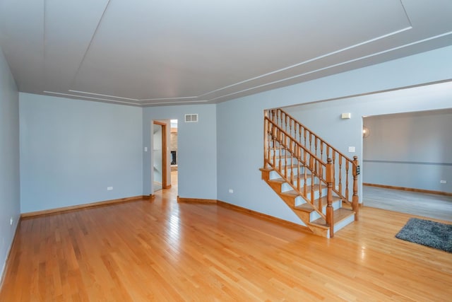 18034 Donatus Dr, Lansing, IL 60438 - unfurnished living room with stairway, baseboards, visible vents, and wood finished floors