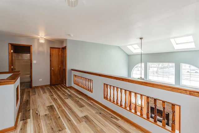 18034 Donatus Dr, Lansing, IL 60438 - hall featuring lofted ceiling with skylight, baseboards, and light wood-type flooring