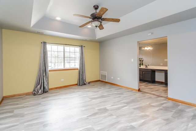18034 Donatus Dr, Lansing, IL 60438 - empty room with ceiling fan, a raised ceiling, baseboards, and visible vents