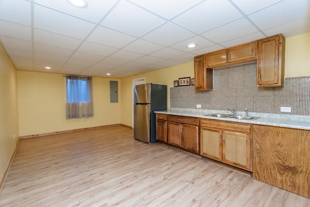 18034 Donatus Dr, Lansing, IL 60438 - kitchen with a sink, tasteful backsplash, freestanding refrigerator, light wood finished floors, and light countertops
