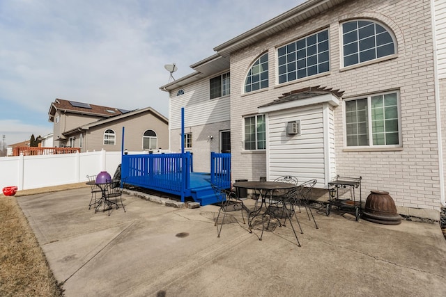 18034 Donatus Dr, Lansing, IL 60438 - rear view of property featuring outdoor dining space, brick siding, fence, a patio area, and a deck