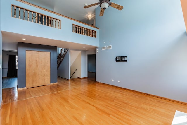 18034 Donatus Dr, Lansing, IL 60438 - unfurnished living room featuring wood finished floors, visible vents, stairway, a ceiling fan, and baseboards