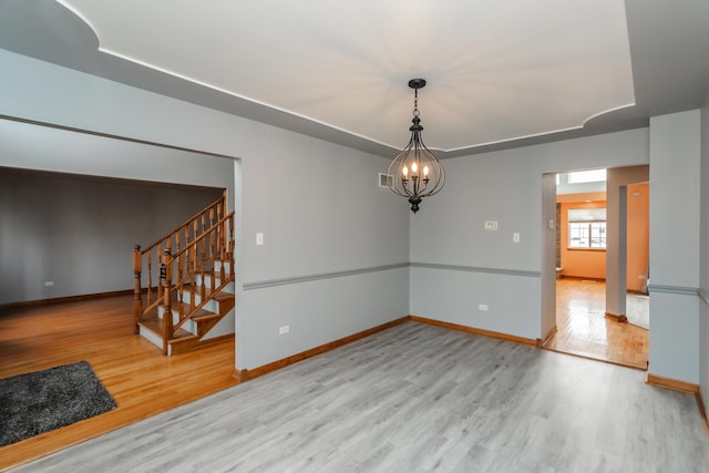 18034 Donatus Dr, Lansing, IL 60438 - spare room with stairway, a raised ceiling, baseboards, and wood finished floors