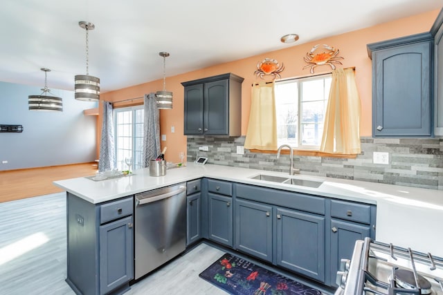 18034 Donatus Dr, Lansing, IL 60438 - kitchen featuring a peninsula, light wood-style flooring, a sink, stainless steel appliances, and tasteful backsplash