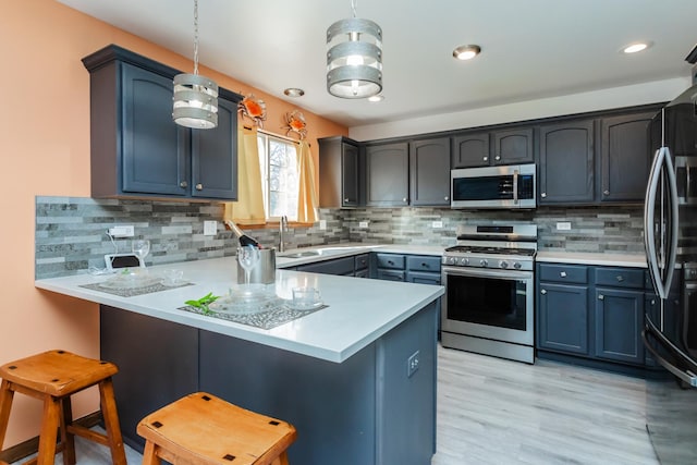 18034 Donatus Dr, Lansing, IL 60438 - kitchen featuring stainless steel appliances, a peninsula, a kitchen bar, and tasteful backsplash