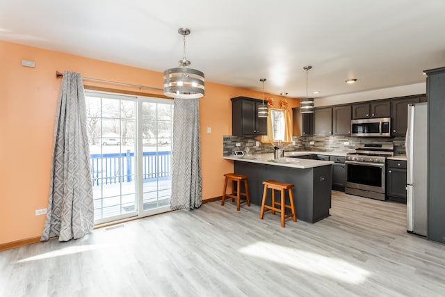 18034 Donatus Dr, Lansing, IL 60438 - kitchen with light wood finished floors, a peninsula, and appliances with stainless steel finishes