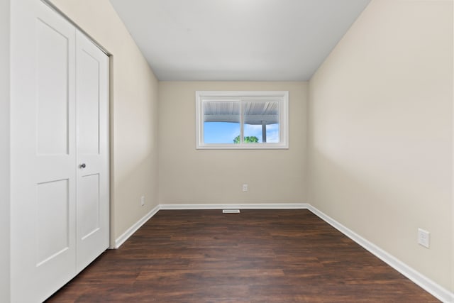 237 N Simmons St, Stockton, IL 61085 - unfurnished bedroom featuring a closet, baseboards, and dark wood-style floors