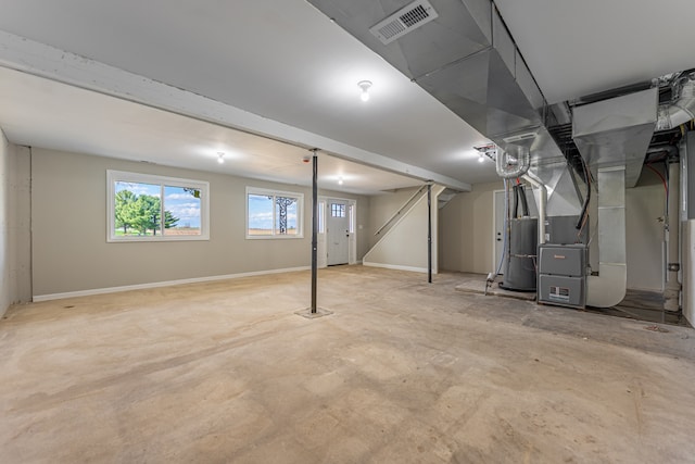 237 N Simmons St, Stockton, IL 61085 - basement featuring baseboards, visible vents, and heating unit