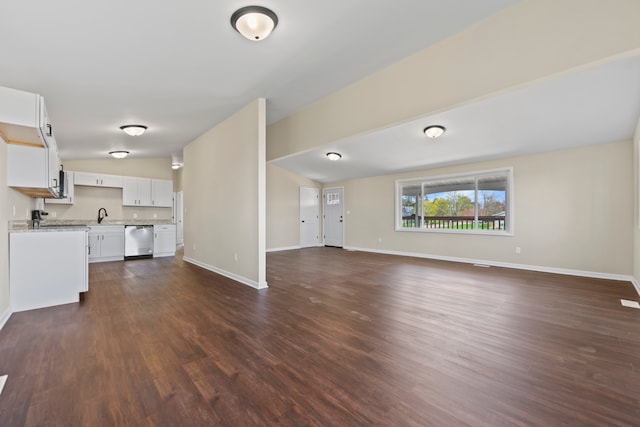 237 N Simmons St, Stockton, IL 61085 - unfurnished living room featuring baseboards, dark wood-style flooring, and a sink