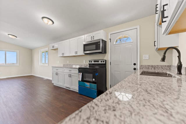 237 N Simmons St, Stockton, IL 61085 - kitchen with a sink, black / electric stove, stainless steel microwave, light stone countertops, and dark wood-style floors