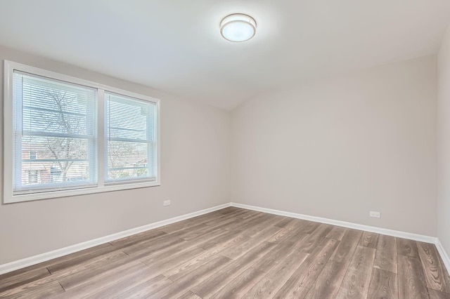 unfurnished room featuring light wood-style floors and baseboards