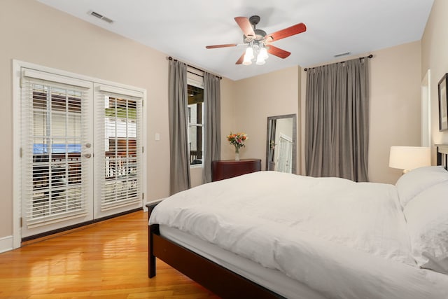 bedroom featuring a ceiling fan, light wood-type flooring, visible vents, and access to exterior