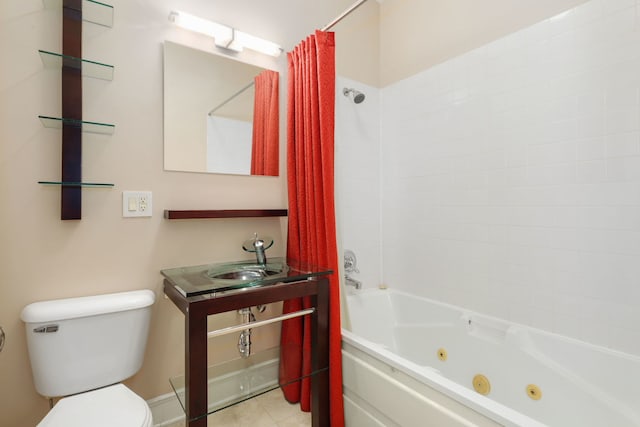 full bathroom featuring a sink, toilet, a combined bath / shower with jetted tub, and tile patterned floors