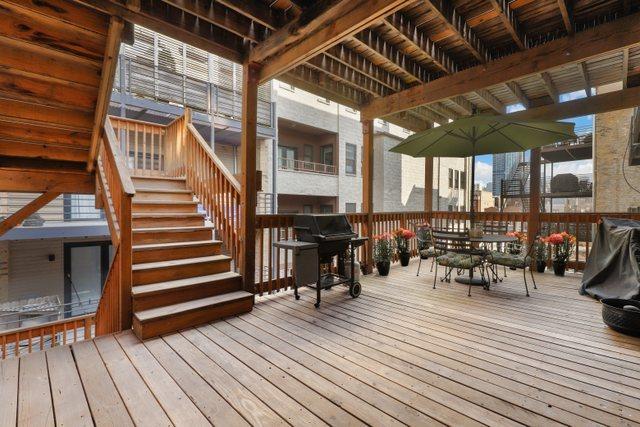 wooden terrace featuring stairway and area for grilling