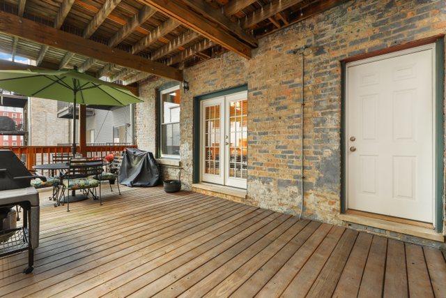 wooden terrace featuring outdoor dining space and french doors