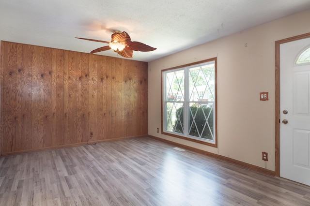 720 Suffolk Pl, Streamwood, IL 60107 - entryway with a ceiling fan, light wood finished floors, and wood walls