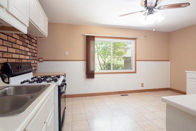 720 Suffolk Pl, Streamwood, IL 60107 - kitchen featuring range with gas stovetop, a wainscoted wall, premium range hood, white cabinets, and ceiling fan