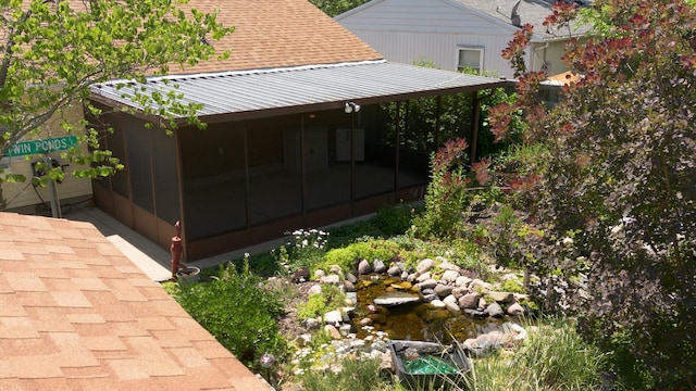 720 Suffolk Pl, Streamwood, IL 60107 - view of property exterior featuring roof with shingles, a sunroom, and a metal roof