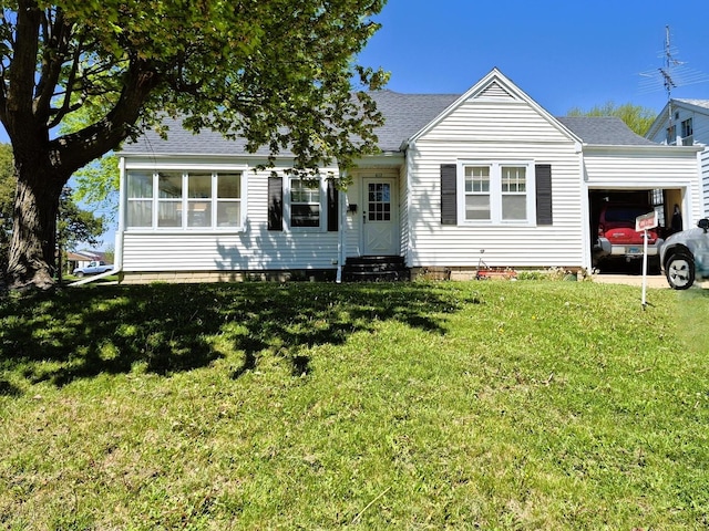 612 W Mason St, Polo, IL 61064 - rear view of property featuring entry steps, an attached garage, a shingled roof, and a lawn