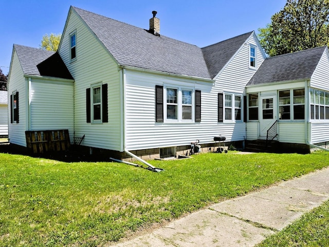 612 W Mason St, Polo, IL 61064 - rear view of property with a chimney, roof with shingles, and a lawn