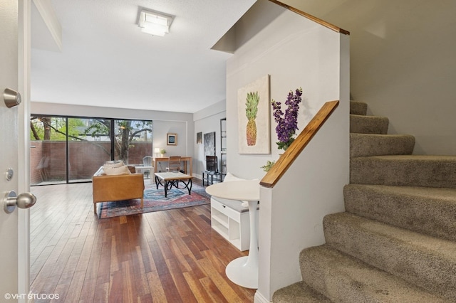 stairway with hardwood / wood-style floors