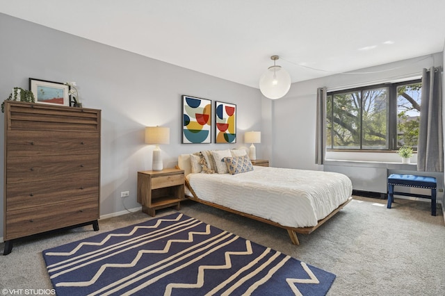 carpeted bedroom featuring baseboards