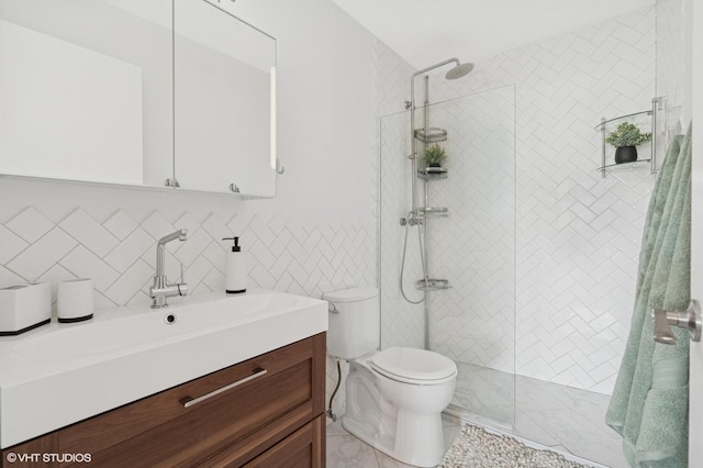 full bathroom with toilet, a stall shower, vanity, and tile walls